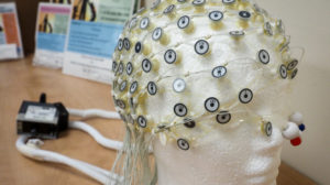 An EEG net can record brain activity while a baby is sleeping and show how brain development differs between preterm infants who received Family Nurture Intervention in the NICU and those who did not.