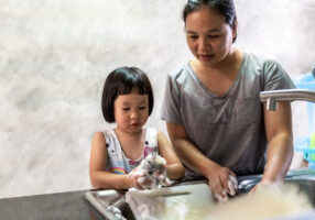 Asian,Girl,Washing,Dish,And,Tableware,With,Her,Mom,,Housework