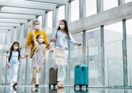 Family,With,Two,Children,Going,On,Holiday,,Wearing,Face,Masks